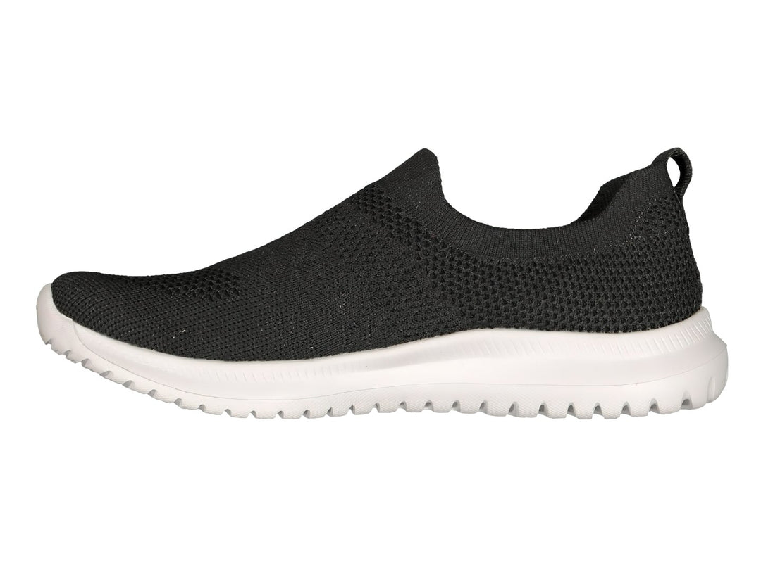 Tenis deportivos Charly color negro con suela blanca, diseño slip-on sin agujetas.