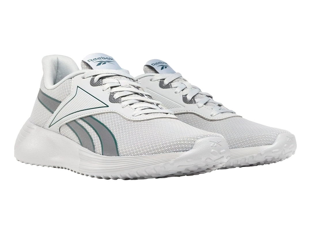 Tenis deportivos Reebok color gris con suela blanca y detalles en azul.