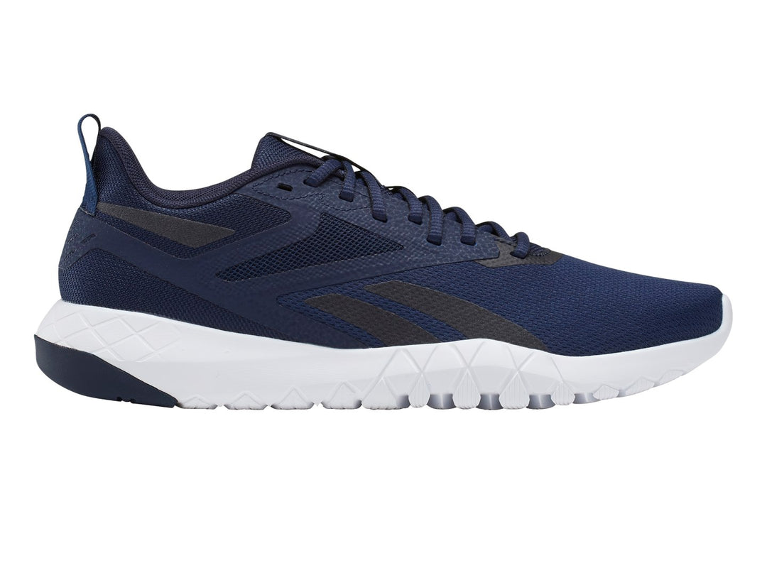 Tenis deportivos Reebok color azul marino con suela blanca y detalles en negro.