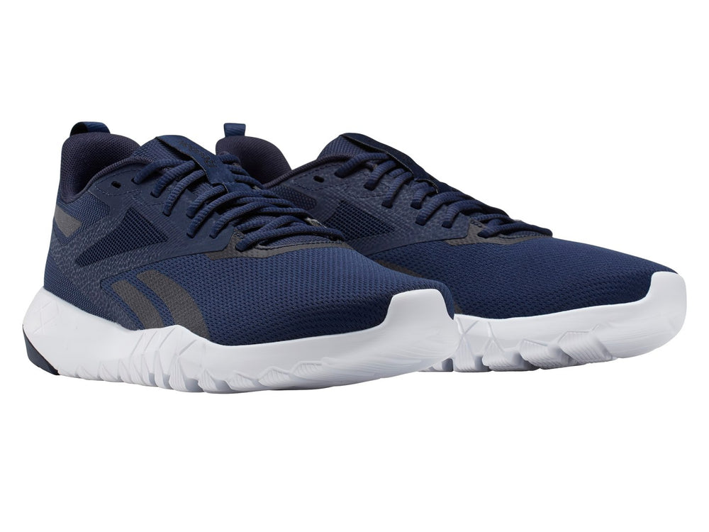 Tenis deportivos Reebok color azul marino con suela blanca y detalles en negro.