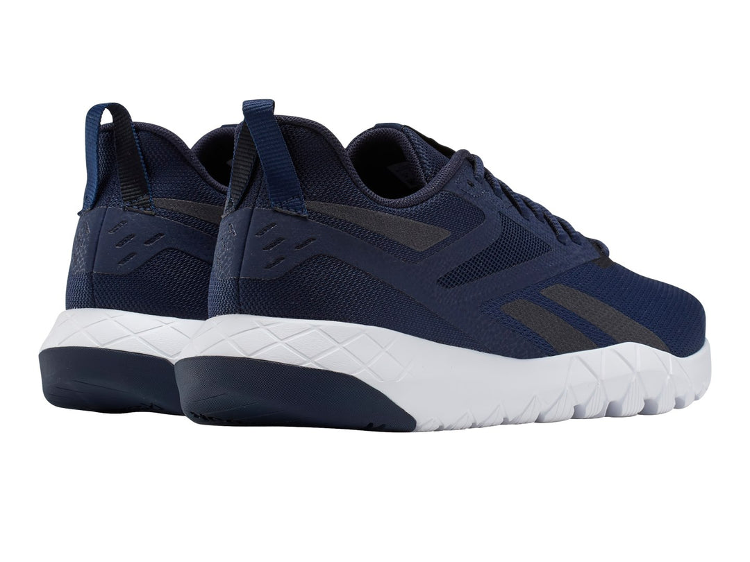 Tenis deportivos Reebok color azul marino con suela blanca y detalles en negro.