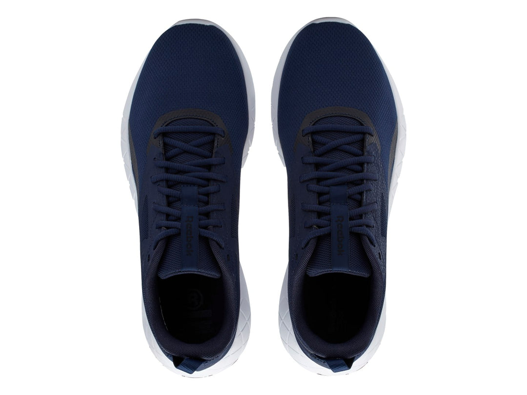 Tenis deportivos Reebok color azul marino con suela blanca y detalles en negro.