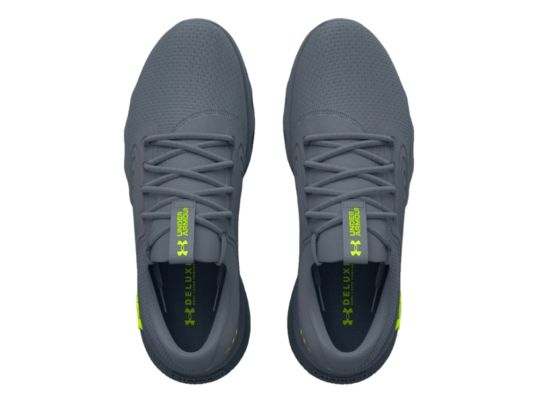 Tenis deportivos Under Armour color gris con logotipo en verde neón, vista lateral.