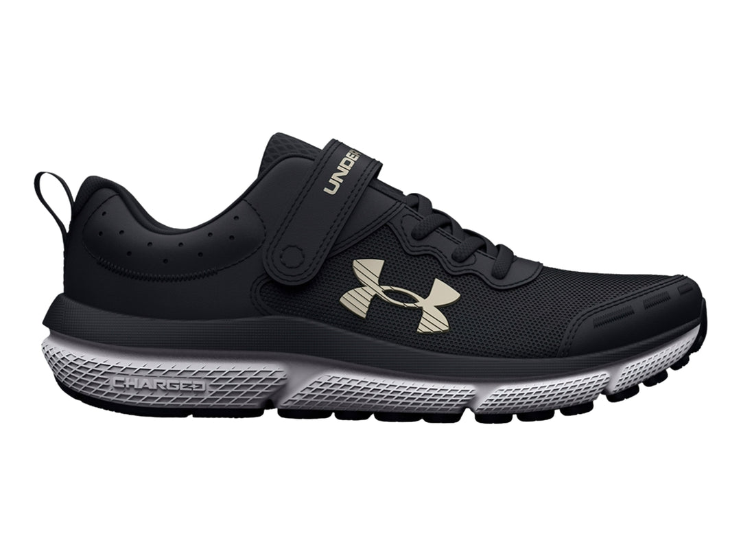 Tenis deportivos Under Armour color negro con suela blanca y cierre de correa de velcro.