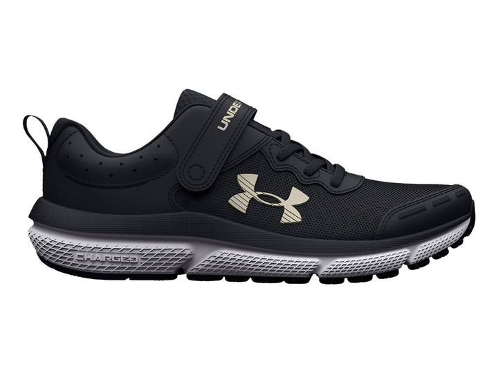 Tenis deportivos Under Armour color negro con suela blanca y cierre de correa de velcro.