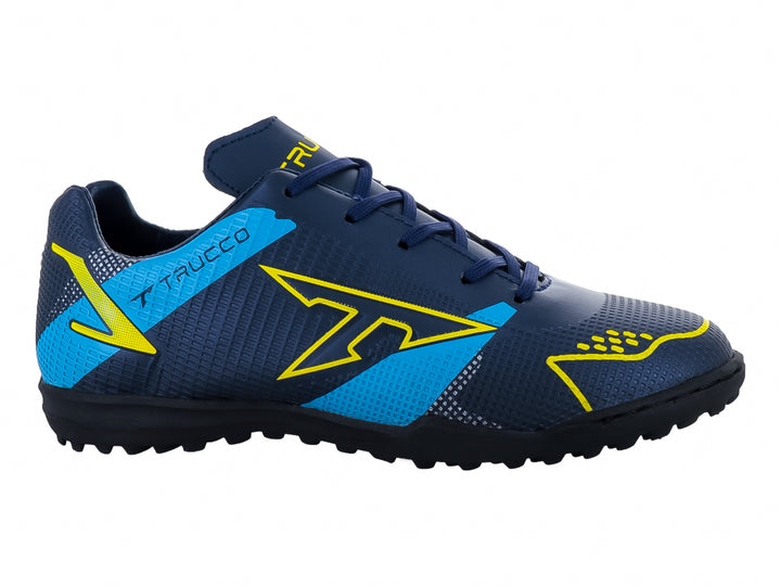 Zapato de fútbol Leon Trucco color marino con detalles amarillos y azules, ideal para canchas sintéticas.