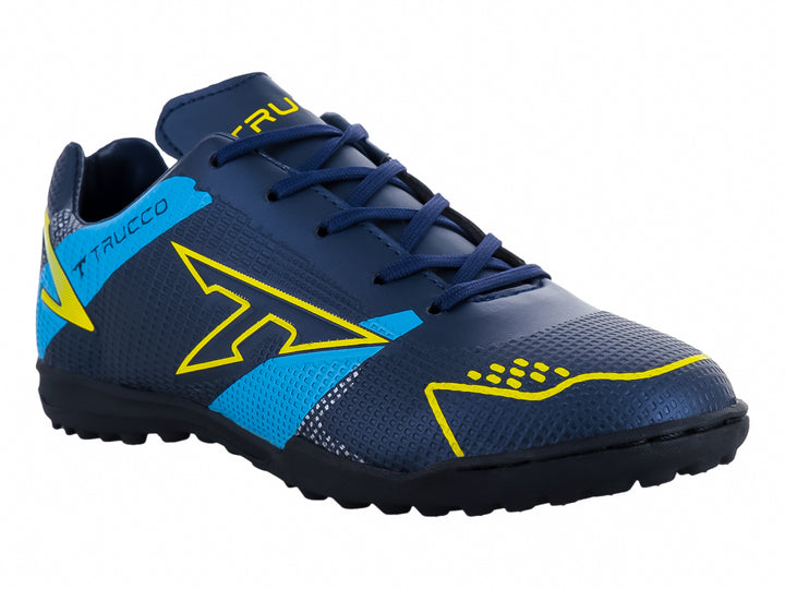 Zapato de fútbol Leon Trucco color marino con detalles amarillos y azules, ideal para canchas sintéticas.