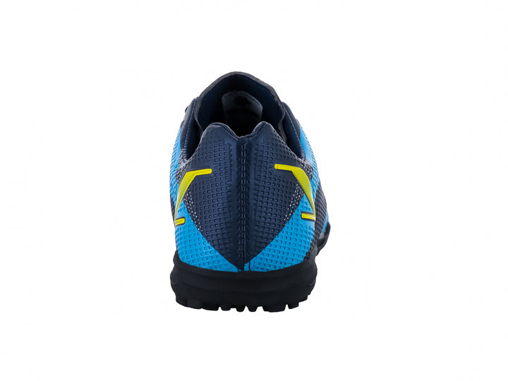 Zapato de fútbol Leon Trucco color marino con detalles amarillos y azules, ideal para canchas sintéticas.