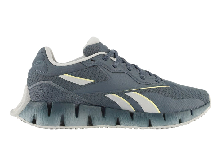 Tenis Reebok Zig Dynamica 4 en color azul con detalles en gris y amarillo, vista lateral.