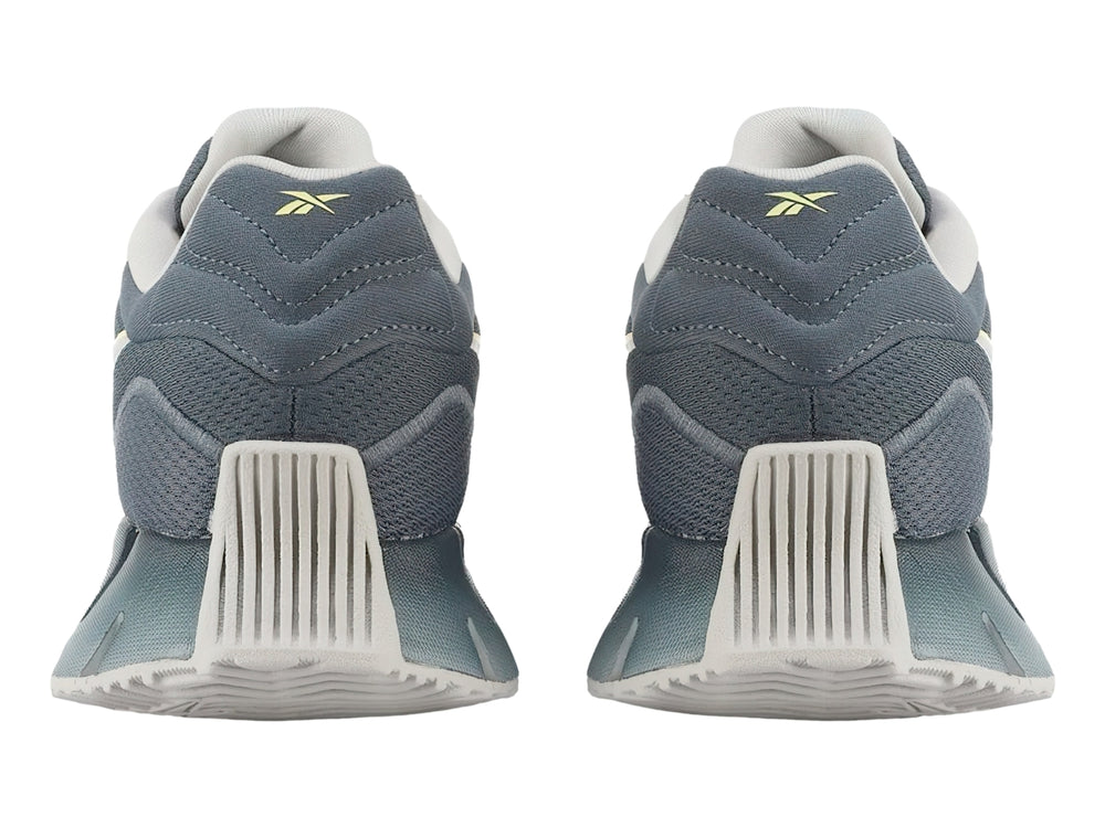 Tenis Reebok Zig Dynamica 4 en color azul con detalles en gris y amarillo, vista lateral.
