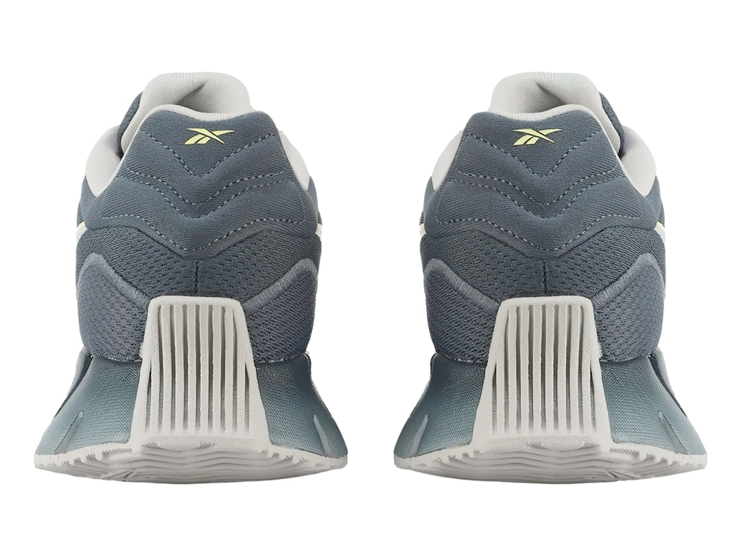 Tenis Reebok Zig Dynamica 4 en color azul con detalles en gris y amarillo, vista lateral.
