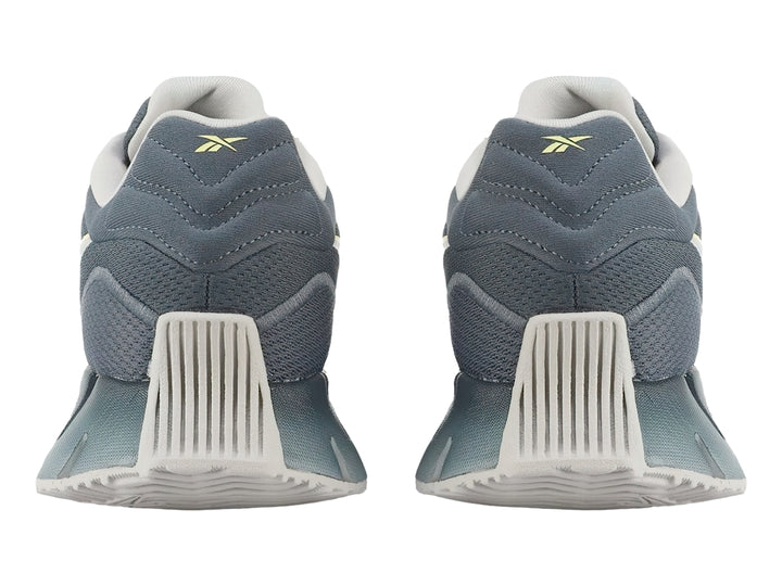 Tenis Reebok Zig Dynamica 4 en color azul con detalles en gris y amarillo, vista lateral.
