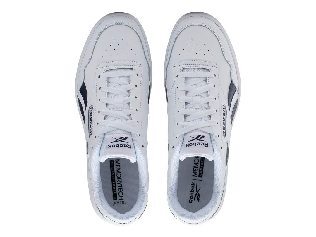 Tenis Reebok blancos con detalles en azul marino y suela blanca.