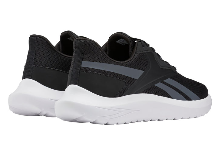 Tenis deportivos Reebok color negro con franjas grises y suela blanca.