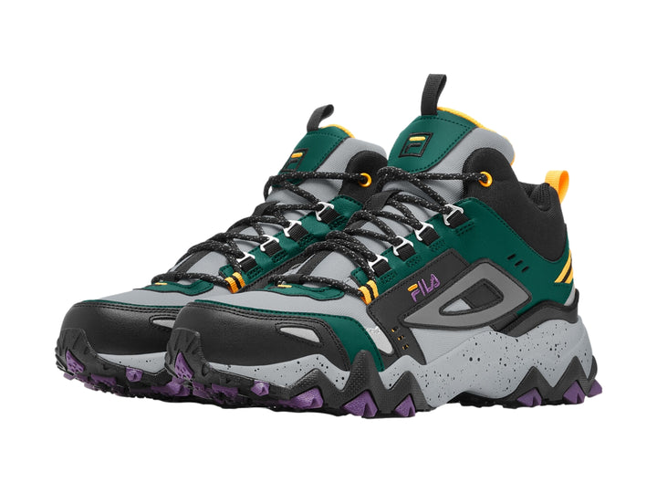 Tenis FILA Oakmont TR Mid en colores verde, negro y gris con suela robusta púrpura y detalles dorados.