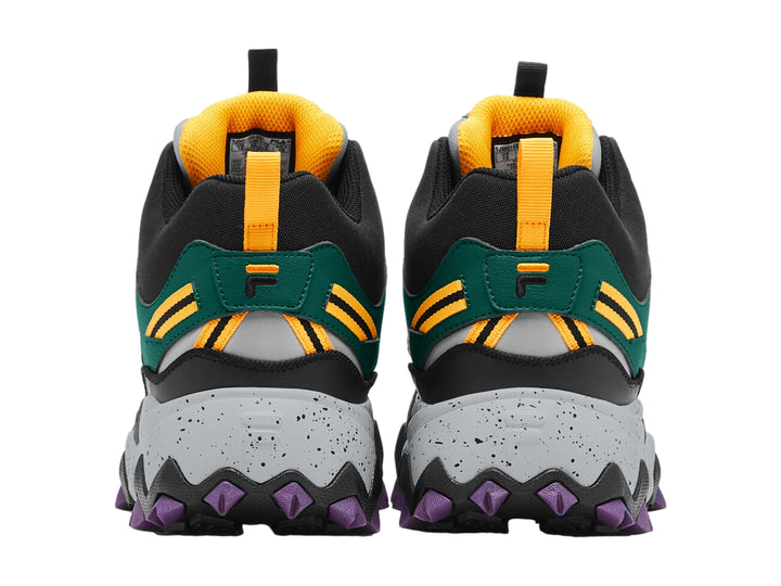 Tenis FILA Oakmont TR Mid en colores verde, negro y gris con suela robusta púrpura y detalles dorados.
