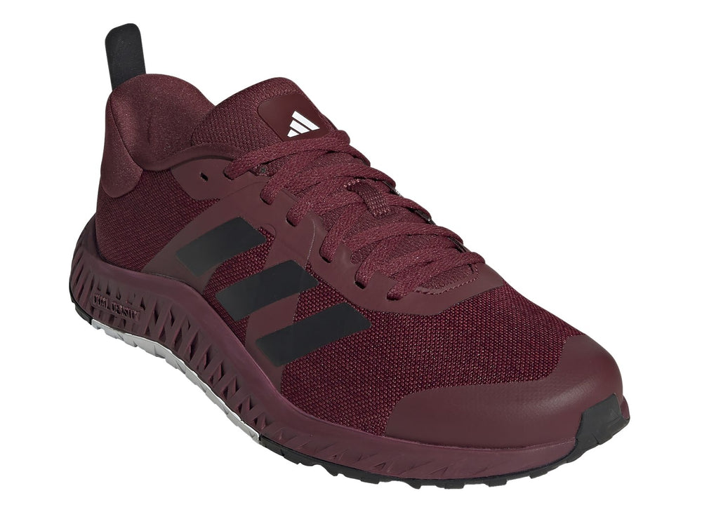Tenis deportivos Adidas color rojo oscuro con franjas negras y suela blanca y negra.