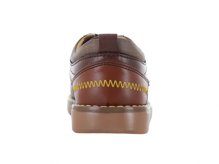 Zapato infantil color castaño con agujetas y suela de goma marrón claro.