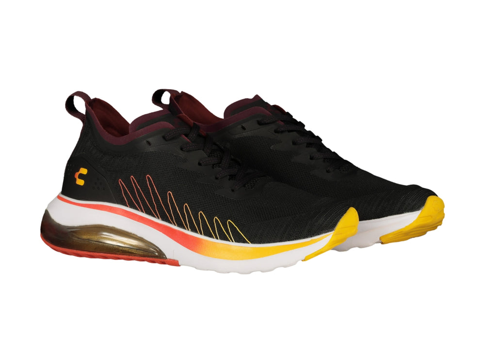 Tenis deportivos Charly color negro con suela degradada en naranja y amarillo y cámara de aire.