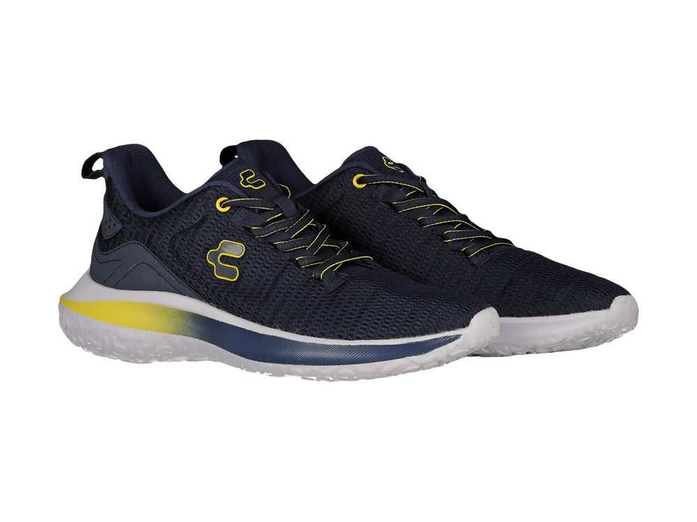 Tenis deportivos Charly en color azul marino con detalles amarillos y suela blanca.