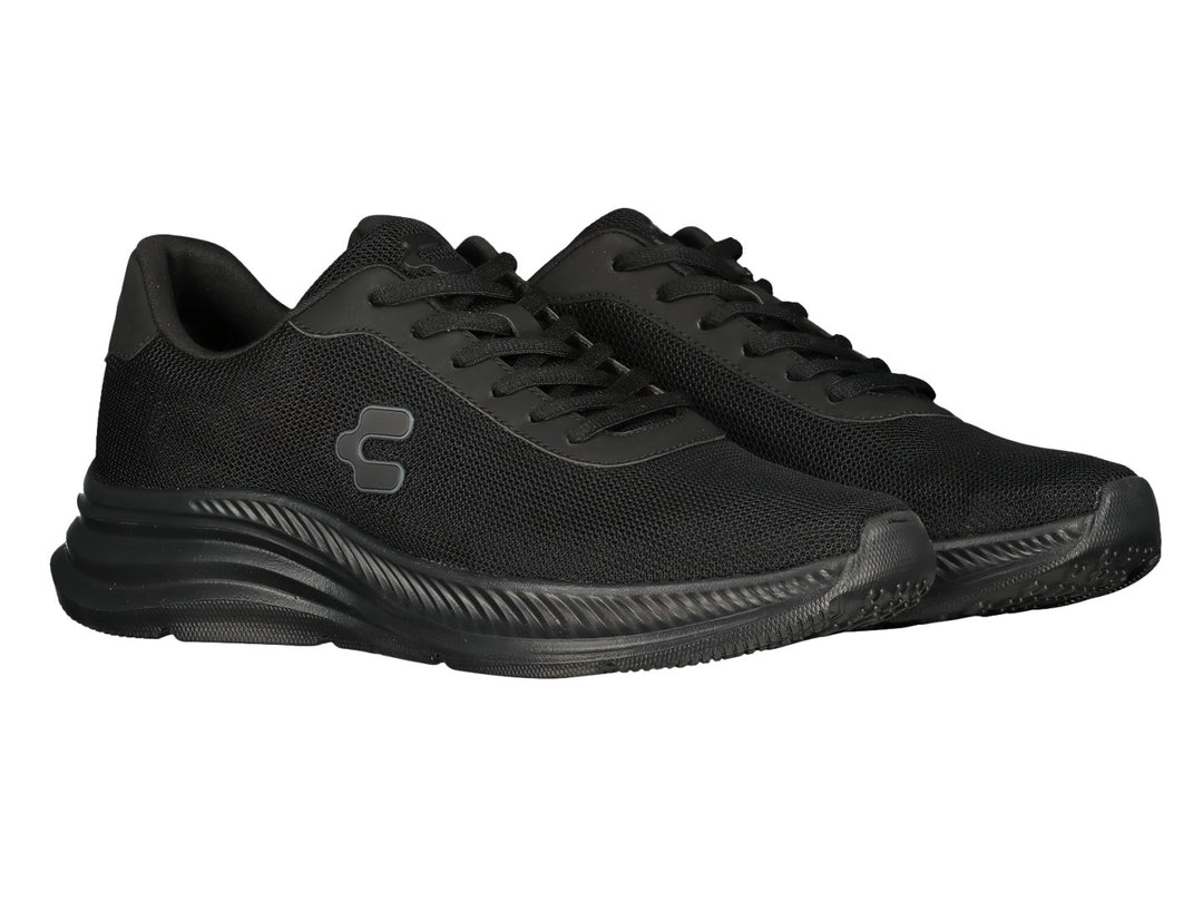 Par de tenis deportivos Charly color negro con malla transpirable y suela texturizada.