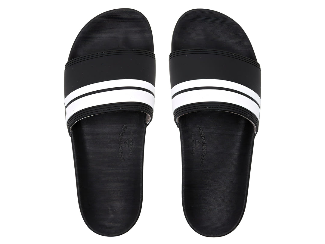 Sandalia slide Quiksilver de color negro con dos franjas blancas laterales y suela negra.