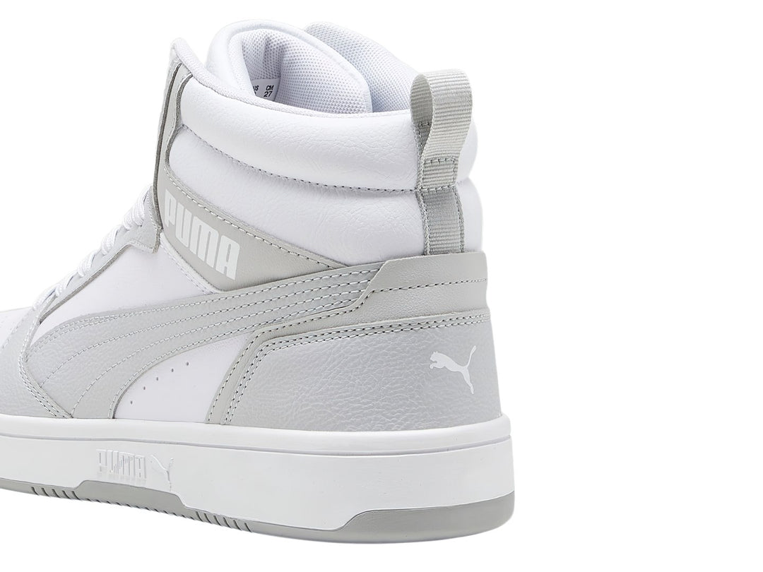 Tenis PUMA Rebound V6 de corte alto en colores blanco y gris ceniza.