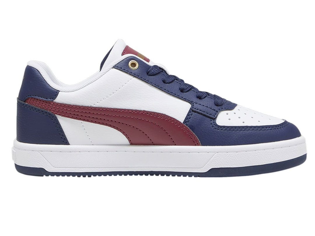 Tenis PUMA Caven 2.0 JR en colores blanco, azul marino y guinda con detalles dorados.