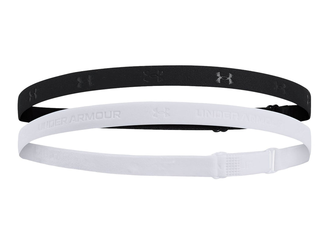 Set de dos bandas elásticas ajustables Under Armour en colores negro y blanco sobre fondo blanco.