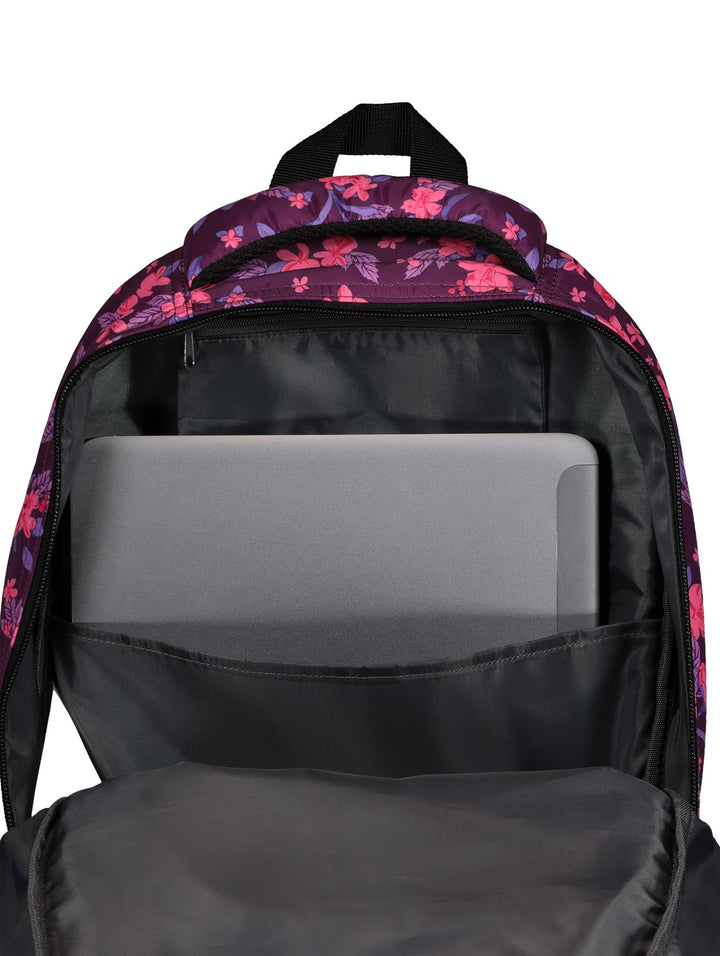 Mochila unisex Charly con estampado floral en tonos fucsia y morado, con detalles y cierres en color negro.