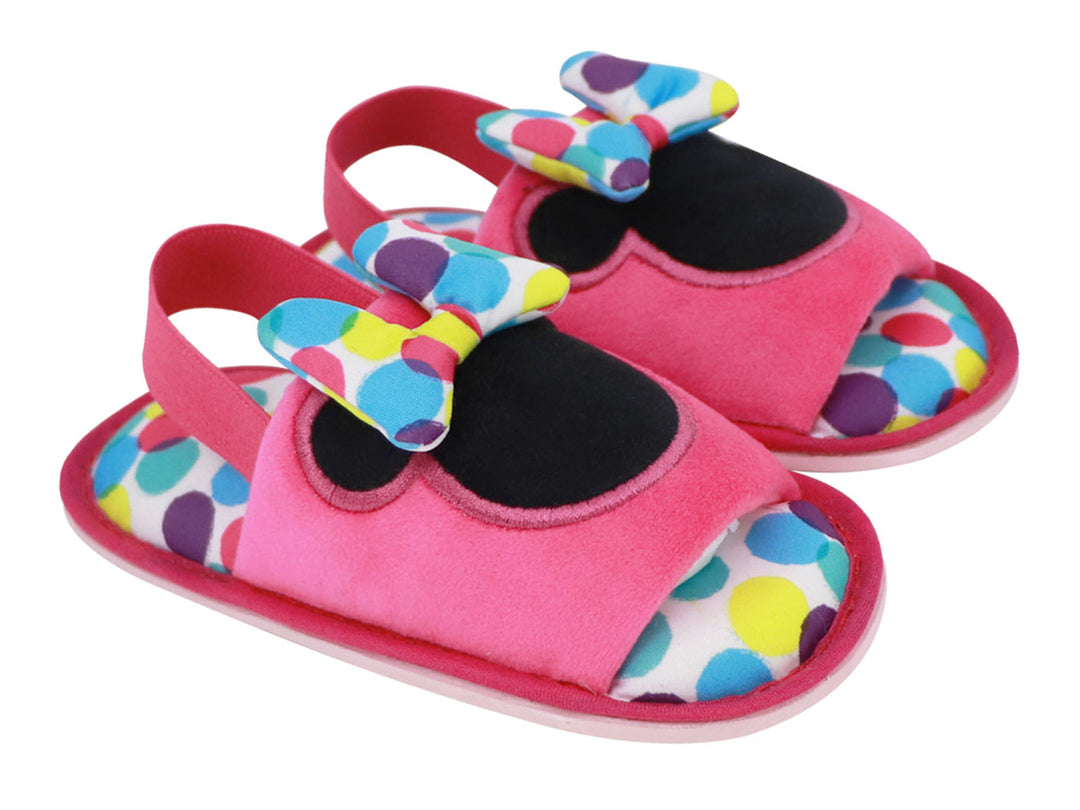 Par de pantuflas rosas infantiles con diseño de Minnie Mouse, moño multicolor y lunares.