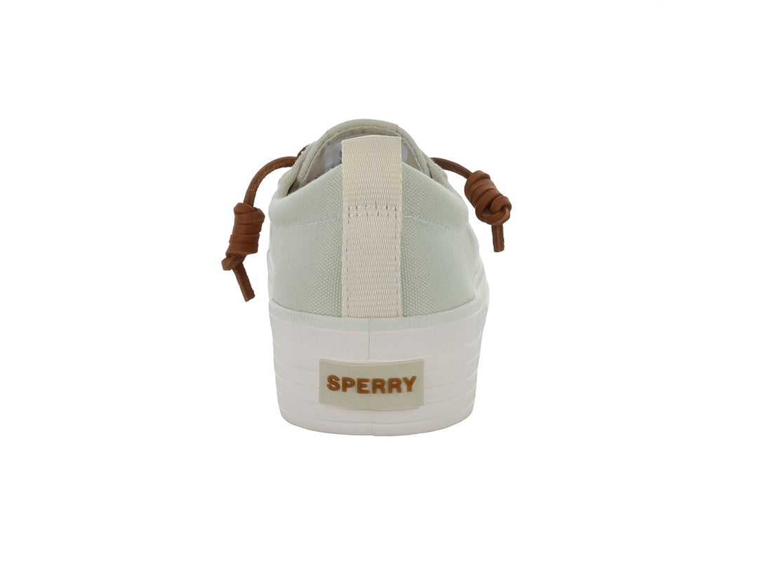 Tenis Sperry color blanco hueso con suela de plataforma blanca y cordones color café.