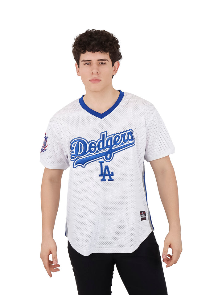 Hombre vistiendo un jersey de béisbol blanco de los Dodgers con detalles en azul.
