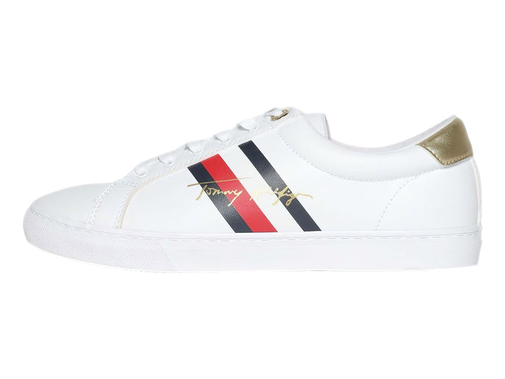 Tenis blancos de Tommy Hilfiger con detalle dorado en el talón y suela blanca.