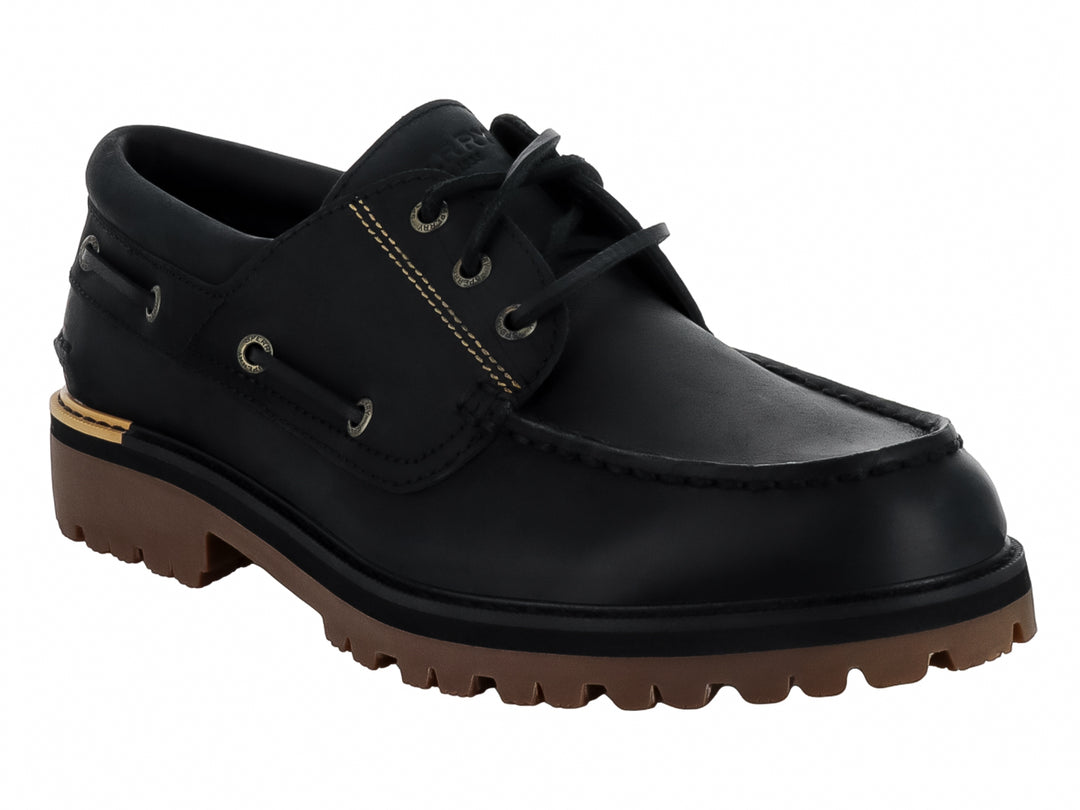 Zapato náutico Sperry de cuero negro con suela track marrón y costuras contrastantes.