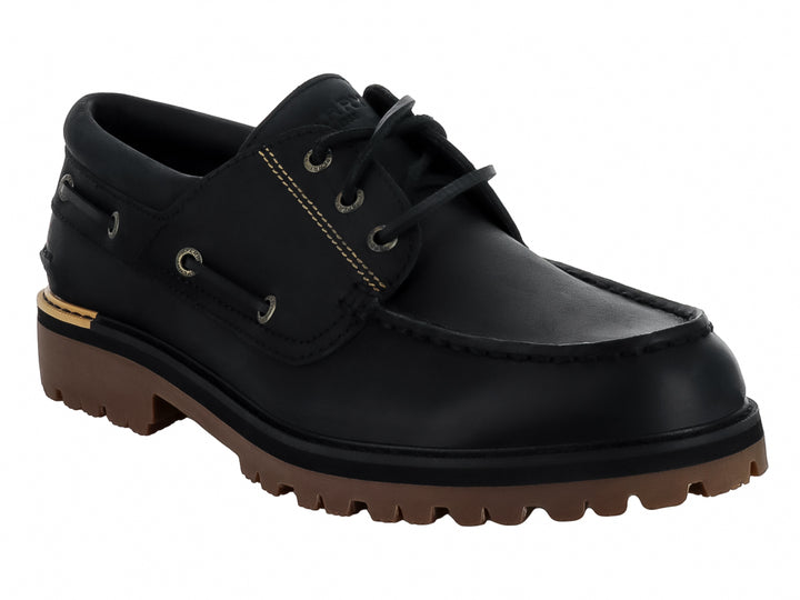 Zapato náutico Sperry de cuero negro con suela track marrón y costuras contrastantes.