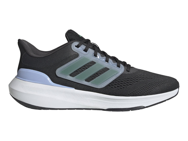 Tenis Adidas Ultrabounce color negro con suela blanca y franjas verdes laterales.