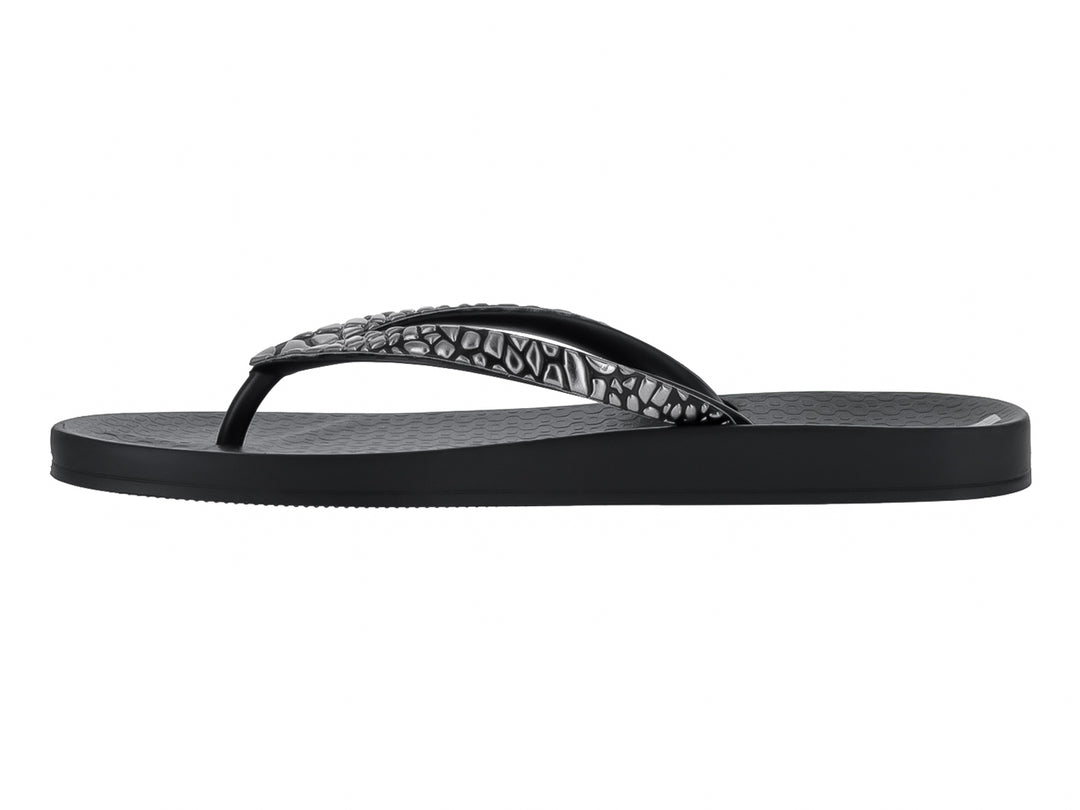 Sandalias negras Ipanema con correa texturizada en color gris y suela plana.