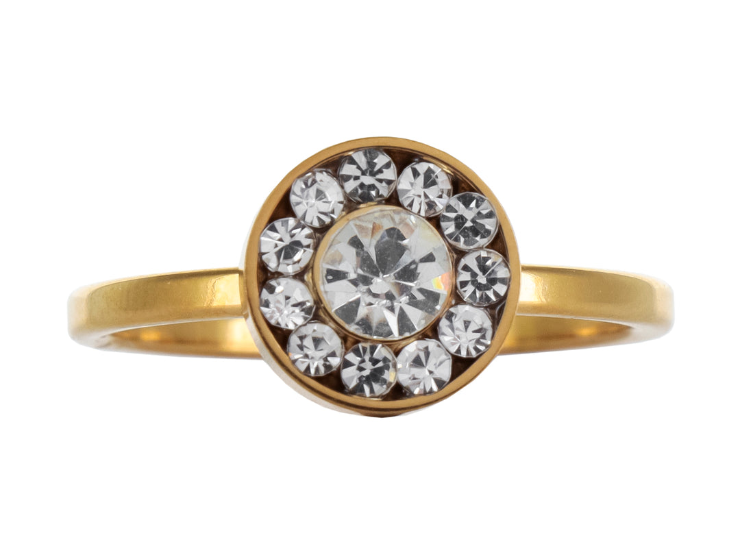 Anillo de color oro con un cristal central grande rodeado por cristales pequeños en forma circular.