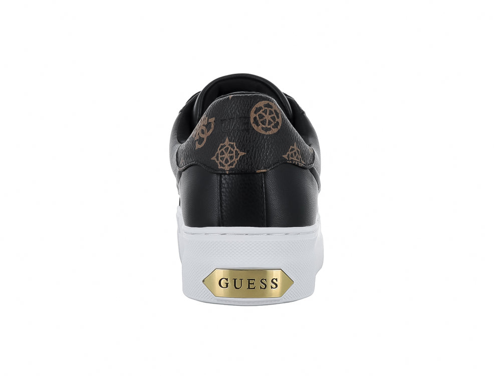 Tenis negros GUESS con suela blanca ancha y detalles decorativos dorados en las agujetas.