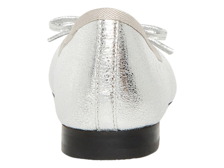 Zapato plano color plata metálico con punta negra y detalle decorativo superior.