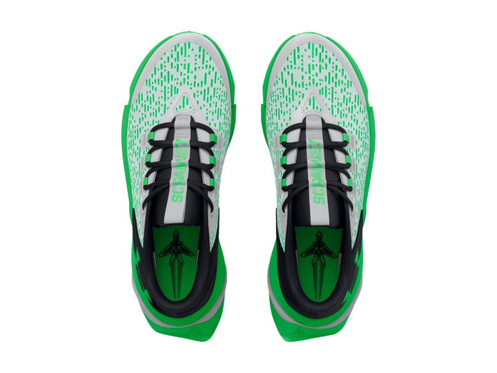 Tenis deportivos Under Armour para niños en colores gris, negro y verde brillante con suela robusta.