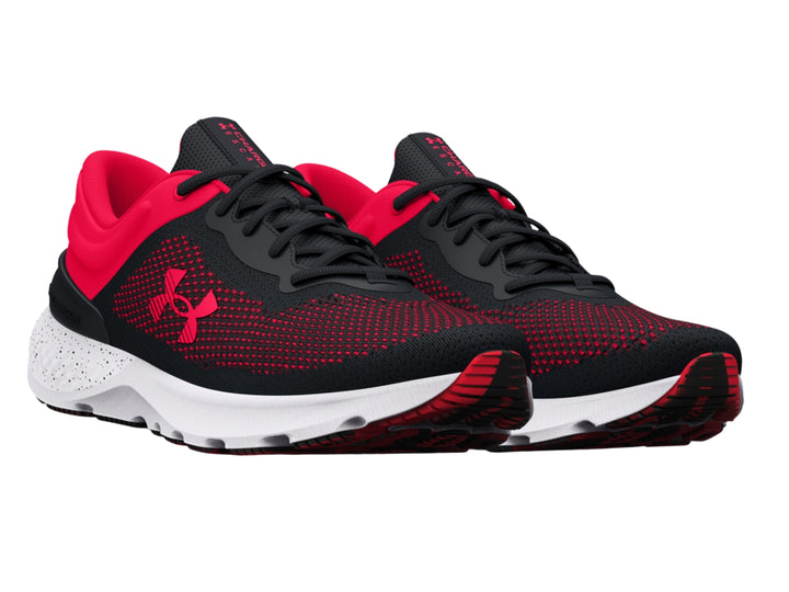 Tenis deportivos Under Armour en colores negro y rosa con suela blanca y tejido transpirable.