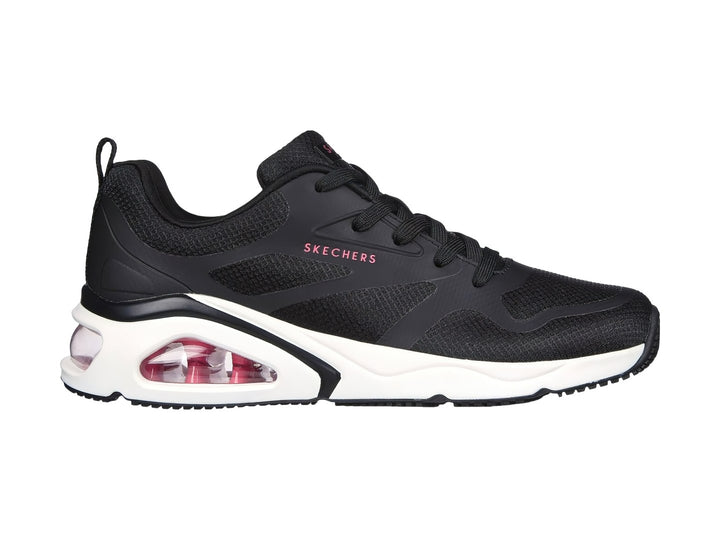 Tenis deportivos Skechers color negro con suela blanca y cámara de aire rosa en el talón.