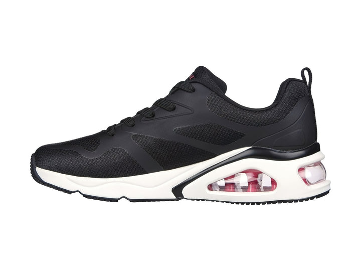 Tenis deportivos Skechers color negro con suela blanca y cámara de aire rosa en el talón.