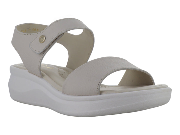 Sandalia color hueso con suela blanca de plataforma y correa ajustable al tobillo.