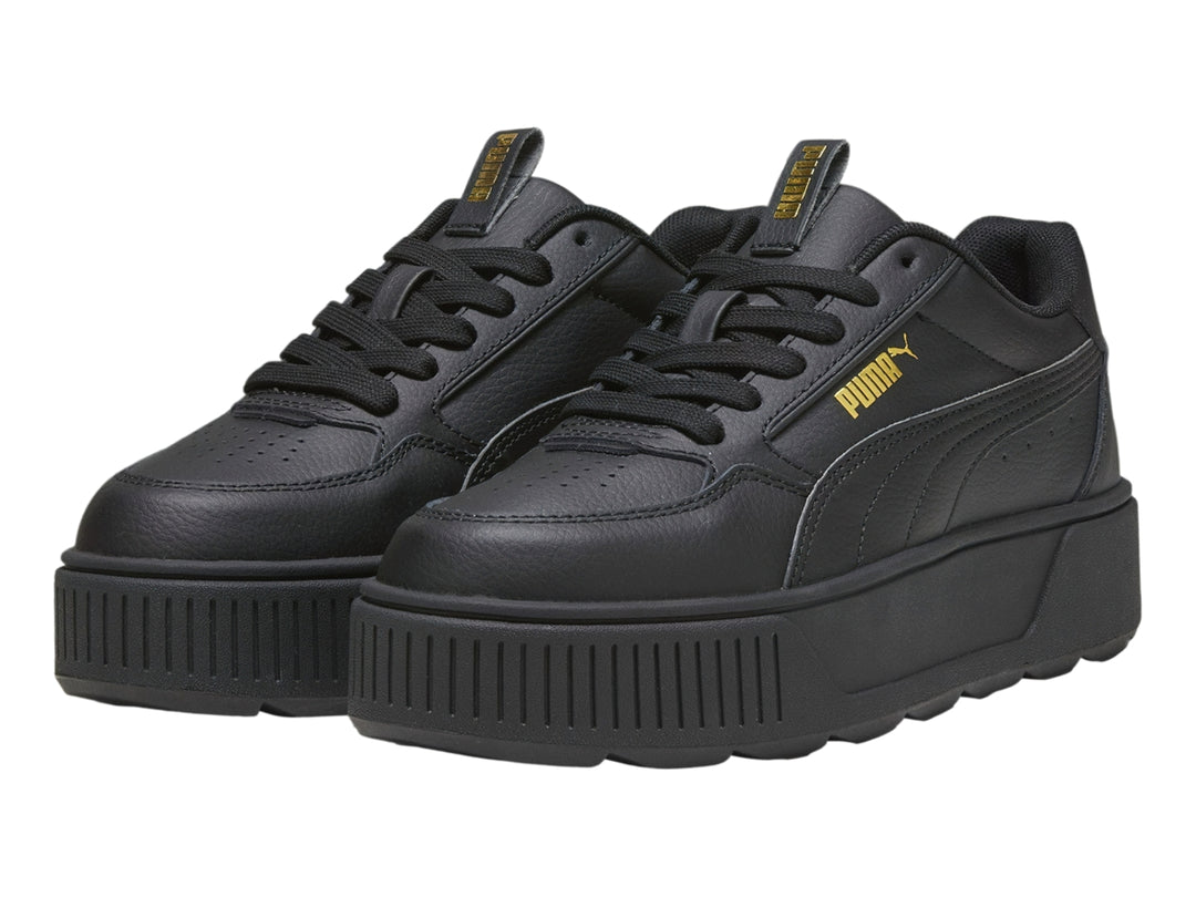 Tenis PUMA color negro con suela de plataforma gruesa y diseño deportivo.