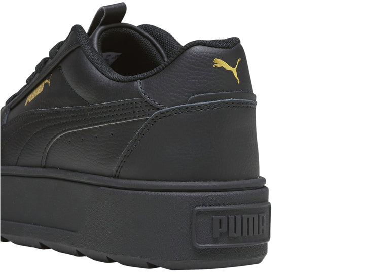 Tenis PUMA color negro con suela de plataforma gruesa y diseño deportivo.