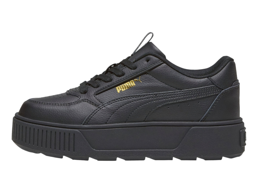 Tenis PUMA color negro con suela de plataforma gruesa y diseño deportivo.