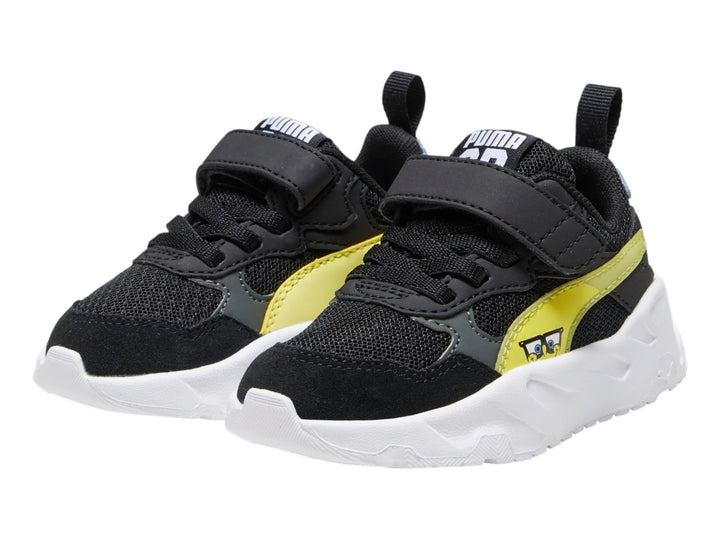 Tenis PUMA infantiles color negro con franja amarilla y suela blanca gruesa.